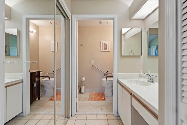 bathroom featuring vanity, tile patterned floors, and toilet