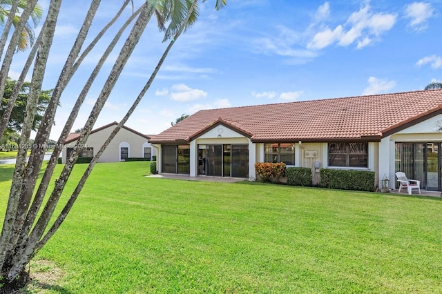 rear view of property featuring a yard