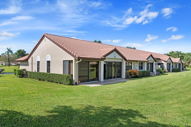 rear view of property with a yard