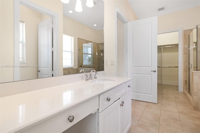 bathroom with vanity, tile patterned floors, and a shower with door