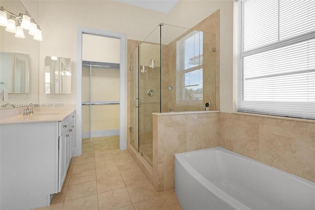 bathroom with tile patterned floors, vanity, and shower with separate bathtub