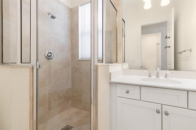 bathroom with vanity and a shower with door