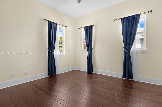 unfurnished room featuring dark wood-type flooring