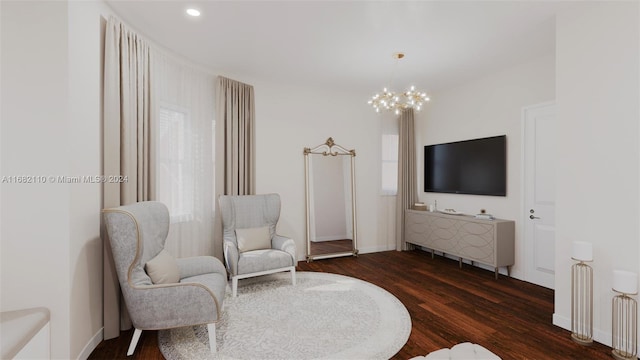 living area featuring dark hardwood / wood-style flooring and a notable chandelier