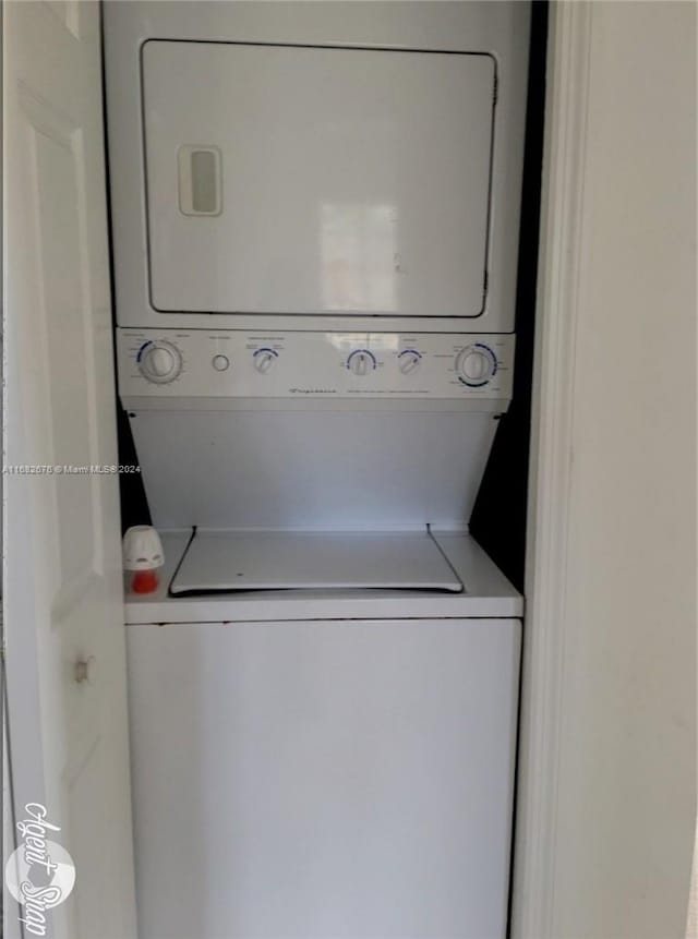 clothes washing area with stacked washer / drying machine