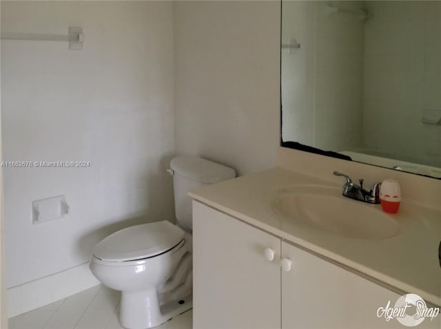 bathroom with vanity, toilet, and tile patterned floors