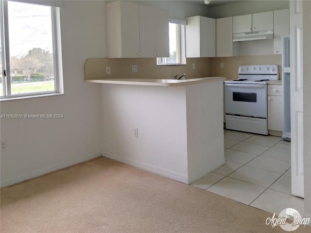 kitchen with kitchen peninsula, light carpet, white range with electric cooktop, white cabinetry, and tasteful backsplash