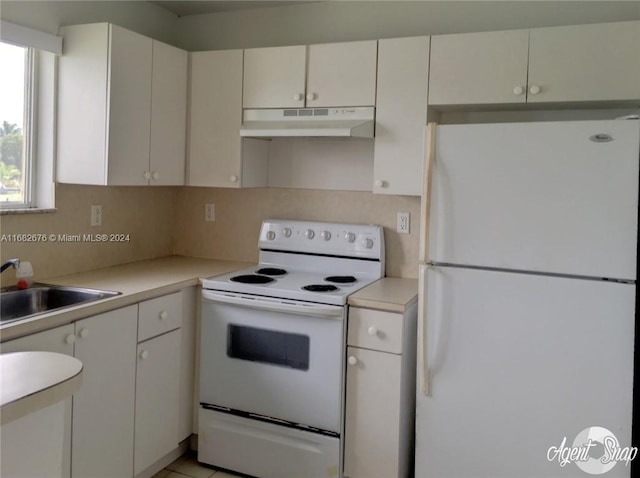 kitchen featuring sink, white cabinets, white appliances, and tasteful backsplash