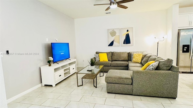 living room featuring light tile patterned flooring and ceiling fan