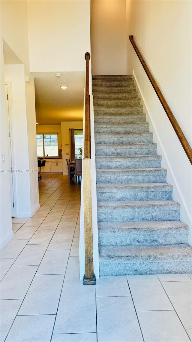 stairs featuring tile patterned floors