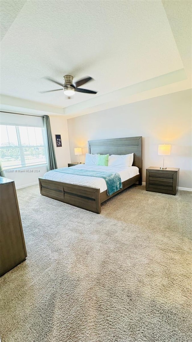 bedroom with carpet floors, a textured ceiling, and ceiling fan