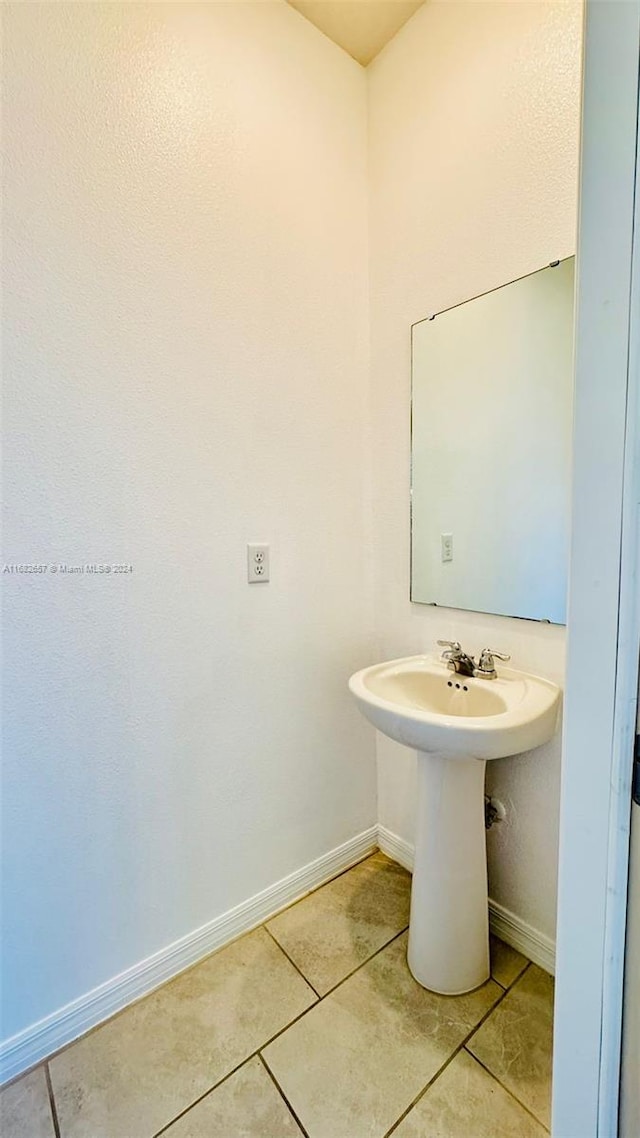 bathroom with sink and tile patterned flooring