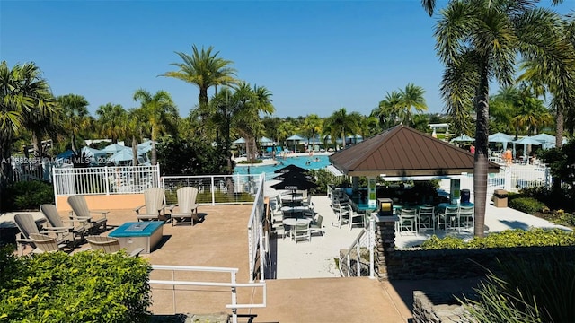 view of dock featuring a gazebo, a patio area, and a community pool