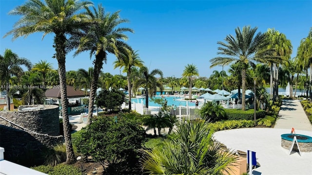 view of property's community featuring a patio and a pool