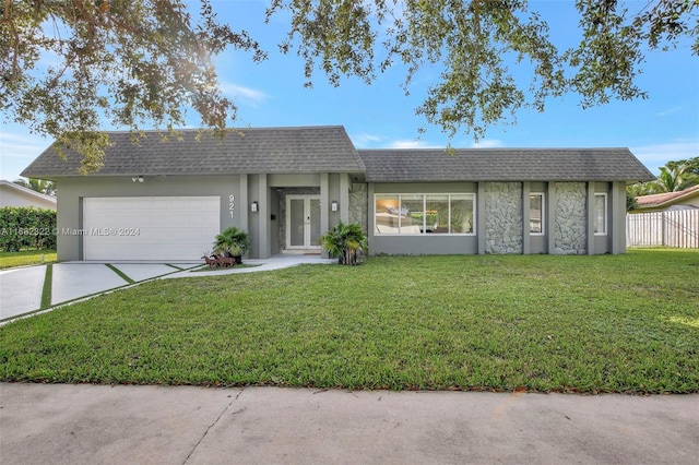 single story home featuring a front yard and a garage