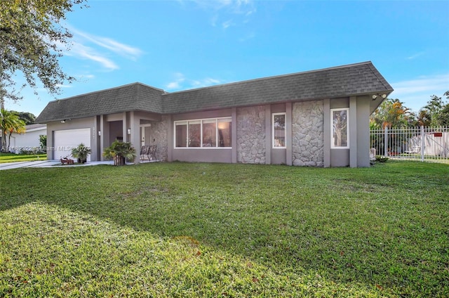 view of front of property featuring a front lawn and a garage