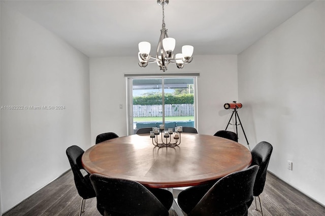 dining space with an inviting chandelier and dark hardwood / wood-style flooring