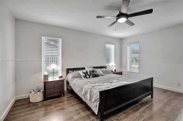 bedroom with ceiling fan and dark hardwood / wood-style floors