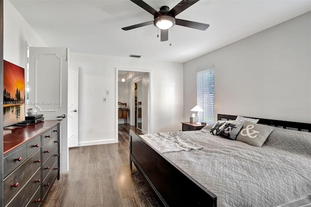 bedroom with dark hardwood / wood-style floors and ceiling fan