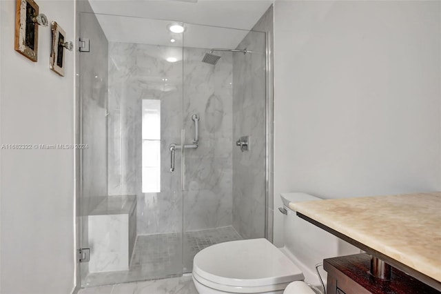 bathroom with a shower with door, vanity, and toilet