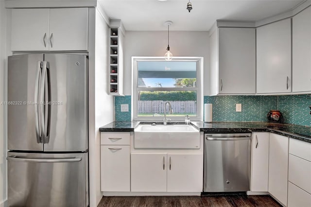 kitchen featuring dark wood-type flooring, stainless steel appliances, white cabinetry, and sink