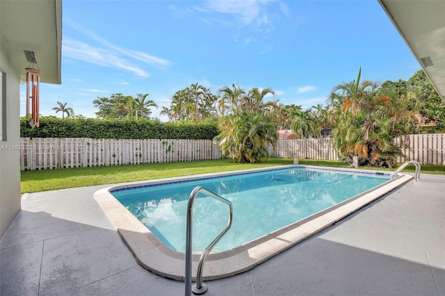 view of swimming pool with a yard and a patio