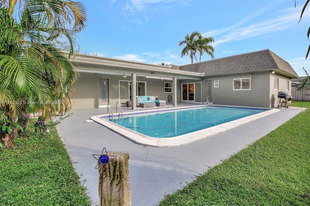 view of pool featuring a patio area, a yard, a grill, and ceiling fan