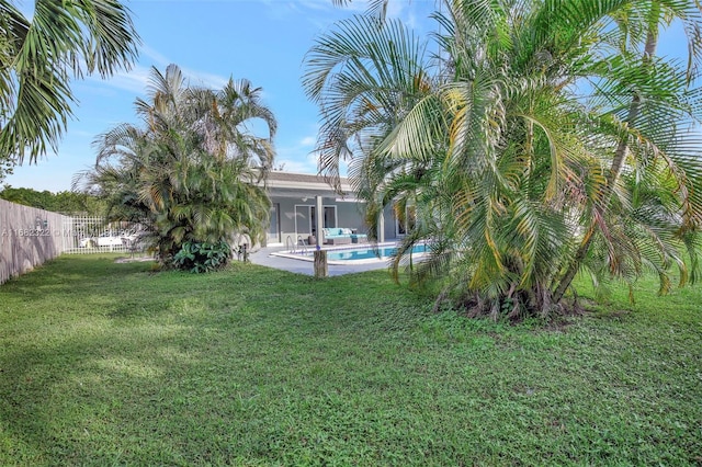 view of yard featuring a patio and a fenced in pool