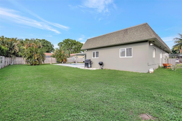 back of property featuring a yard and a patio area