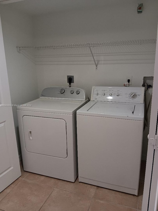 laundry room featuring light tile patterned floors, washer and dryer, and laundry area