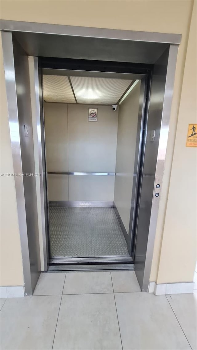 interior space featuring elevator and tile patterned flooring