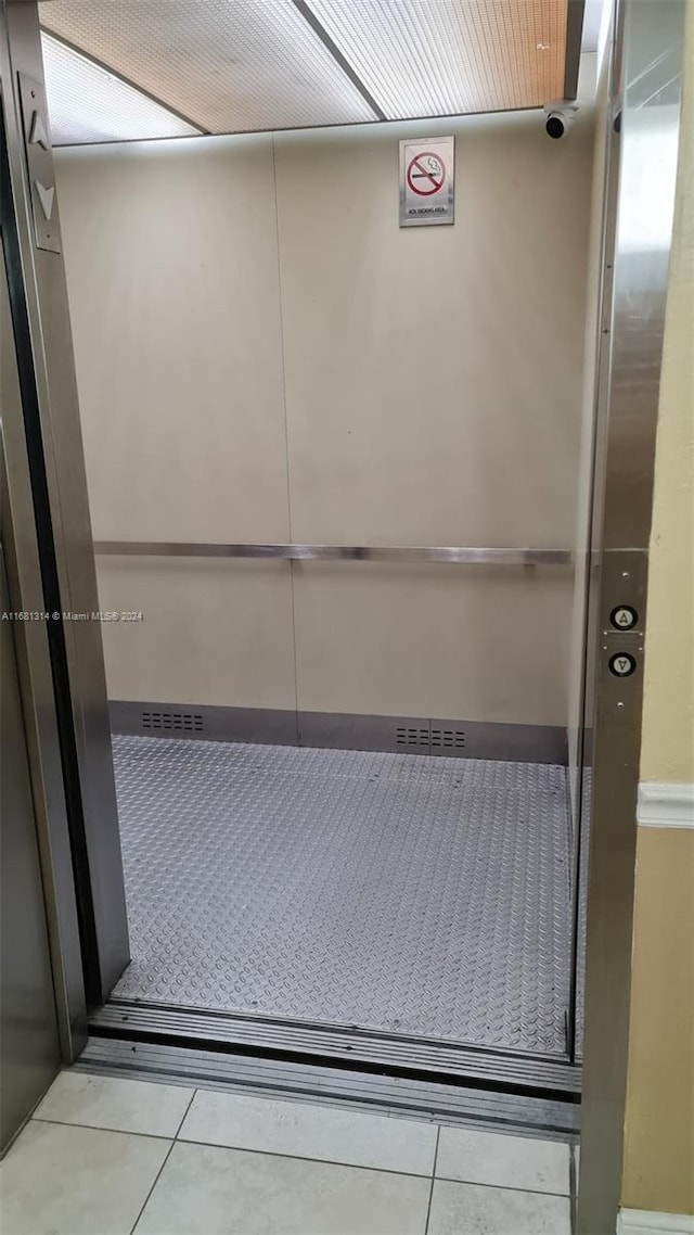 interior details featuring tile patterned floors and elevator