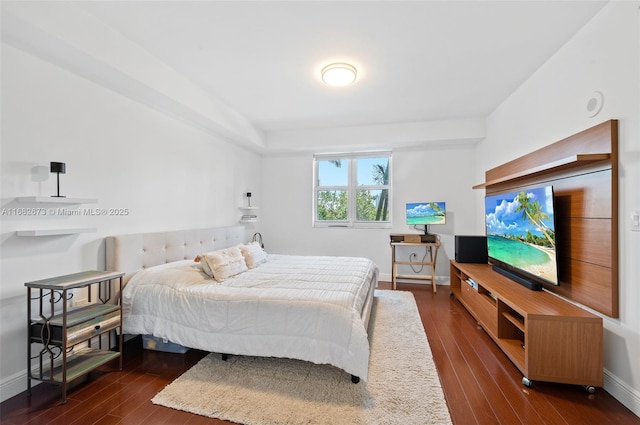 bedroom with dark hardwood / wood-style floors