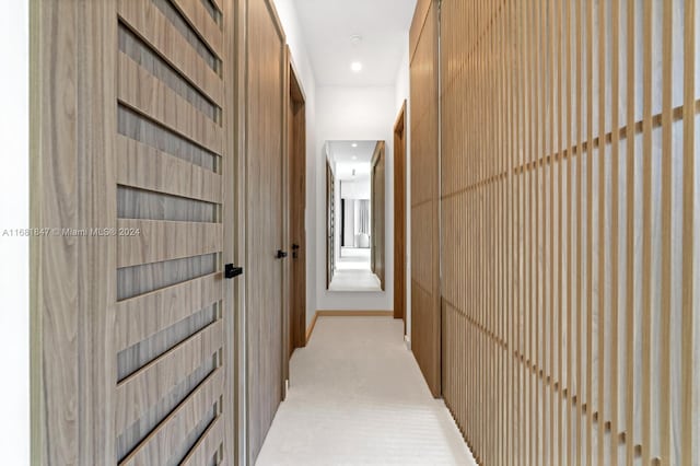 corridor with light colored carpet