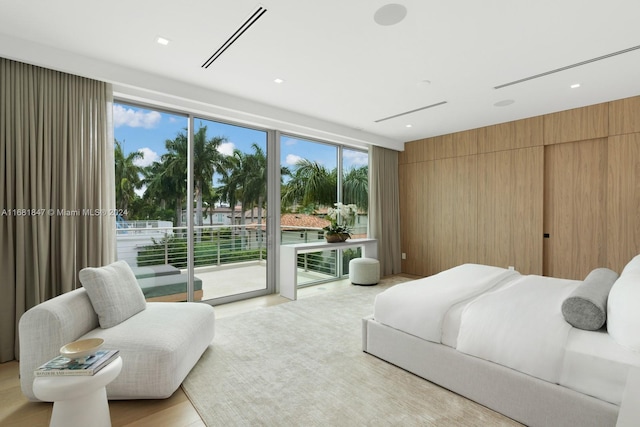 bedroom featuring wooden walls and access to exterior