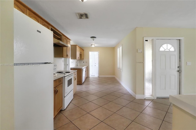 kitchen featuring extractor fan, light tile patterned flooring, sink, and white appliances