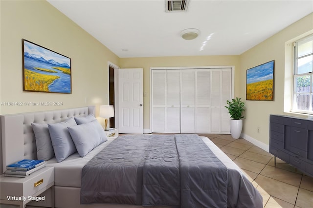 tiled bedroom with a closet