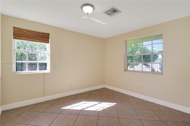 unfurnished room with a healthy amount of sunlight and light tile patterned flooring