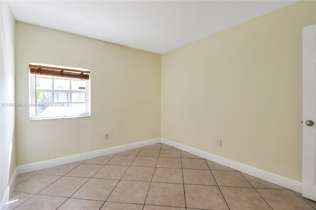 empty room with light tile patterned floors