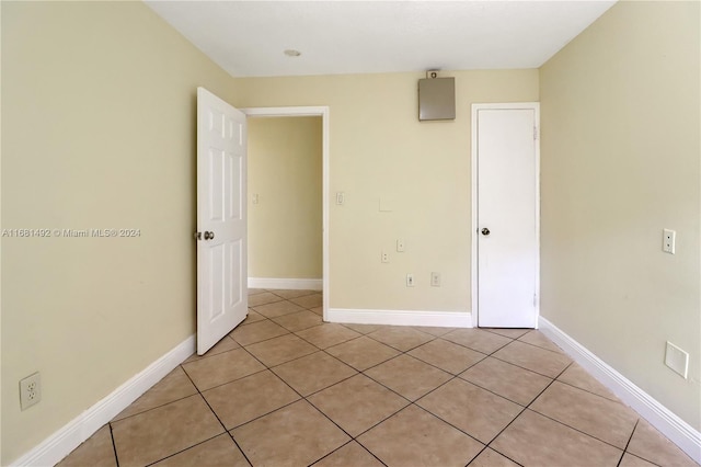 unfurnished bedroom featuring light tile patterned flooring