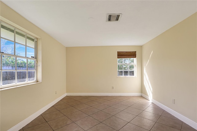 spare room featuring light tile patterned floors