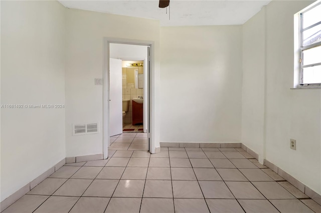 unfurnished room featuring light tile patterned flooring and ceiling fan