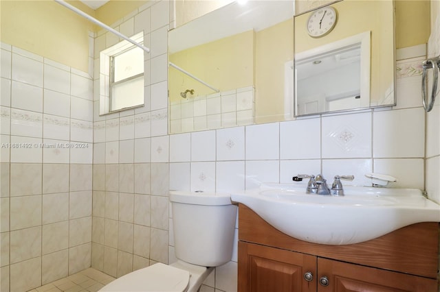 bathroom with decorative backsplash, tile walls, toilet, tiled shower, and vanity