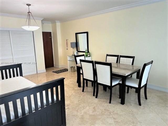 dining area with baseboards and ornamental molding