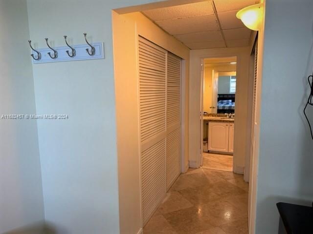 hallway featuring a paneled ceiling