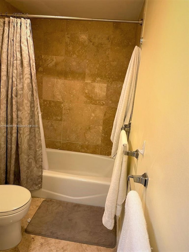 bathroom with toilet and shower / bath combination with curtain