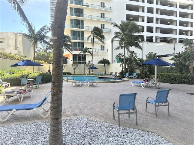 surrounding community featuring a pool and a patio area