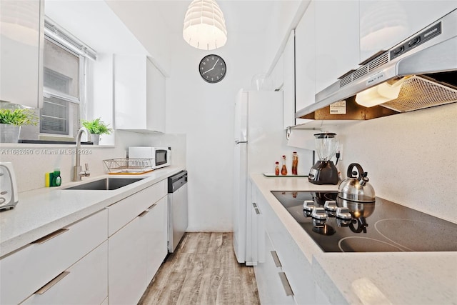 kitchen with white cabinetry, light hardwood / wood-style floors, extractor fan, and white appliances