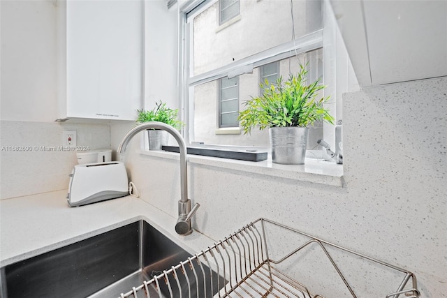 details featuring sink and white cabinets