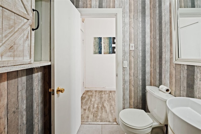 bathroom featuring toilet and tile patterned flooring